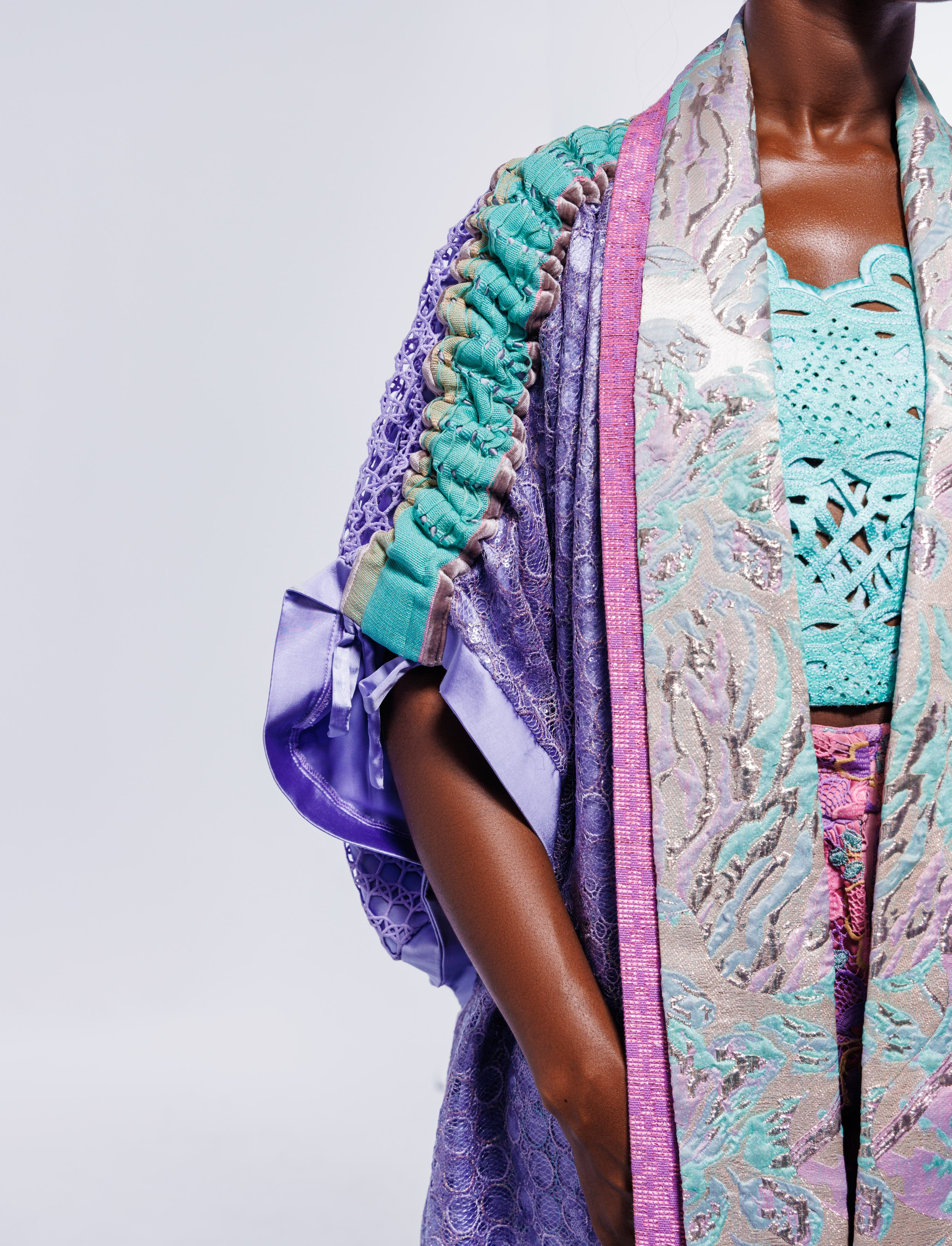 Close crop of MAYYISAH textile detail in aqua, lavender and pink